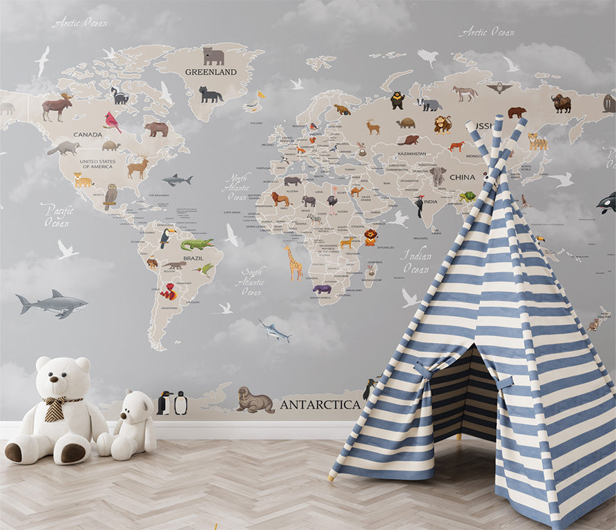 This illustrated world map features animals unique to each region on a gray-toned backdrop. Icons of animals like pandas in China, kangaroos in Australia, and penguins in Antarctica highlight global biodiversity. Surrounded by labeled oceans and a subtle depiction of clouds, the map combines geographic clarity with a playful educational theme.