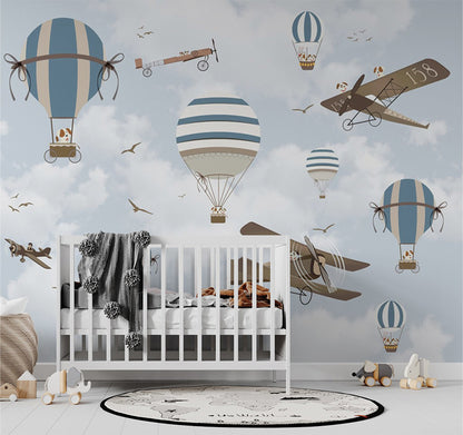 A charming sky scene with vintage airplanes and striped hot air balloons floating among soft clouds. Each aircraft and balloon is piloted by playful cartoon dogs, adding a whimsical and lighthearted touch. The muted blue and beige tones enhance the tranquil, nostalgic feel of this playful design, perfect for a child's room or aviation-themed decor.