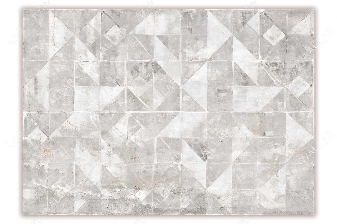 A geometric mural featuring weathered concrete tiles with various triangular and square patterns in soft gray and white tones. The distressed texture adds an industrial, minimalist, and modern aesthetic to the design.