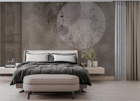 A sophisticated wallpaper mural with a textured taupe background, featuring a minimalist design of delicate branches and leaves overlaying a subtle circular moon motif. The left side includes an ornate vertical border pattern, creating a harmonious blend of nature and abstract elegance. Perfect for a serene and modern interior.