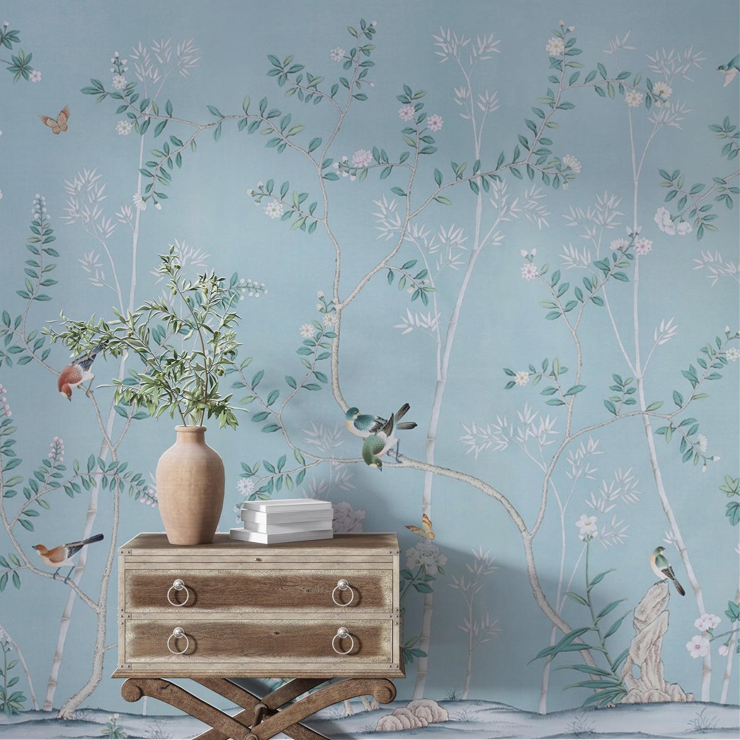 A delicate mural featuring intertwining branches with small blossoms and vibrant birds perched throughout, set against a serene light blue background. The intricate details of flowers, leaves, and butterflies create a tranquil, nature-inspired aesthetic with a timeless elegance