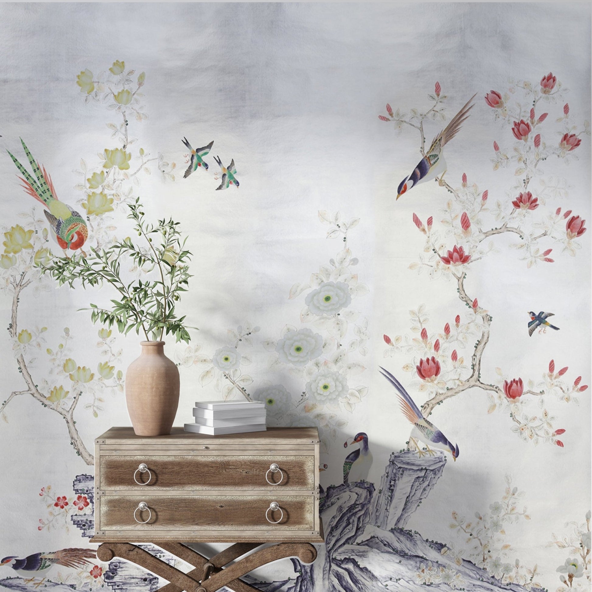 An elegant chinoiserie-inspired design featuring vibrant birds perched on gnarled branches amidst flowering trees with bold red, yellow, and white blossoms. The delicate details of the flora and fauna contrast beautifully against the soft, white background, creating a timeless and serene aesthetic. The intricate composition exudes harmony and grace.